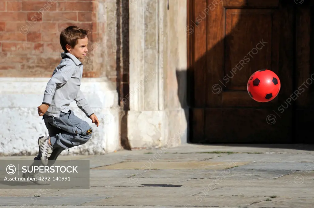 Little boy run with ball