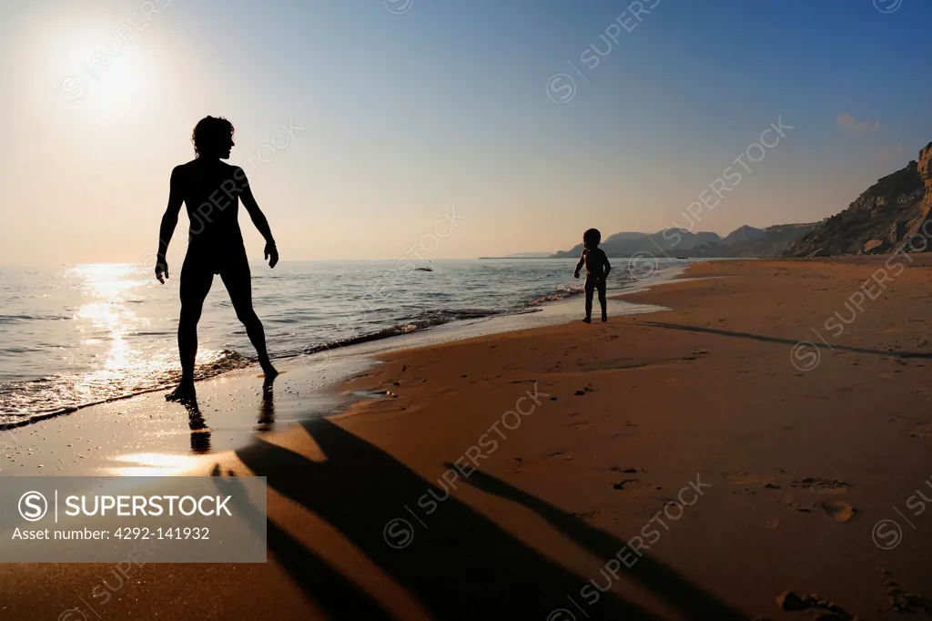 Man and child on the beach