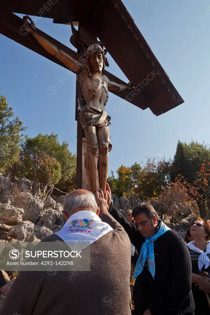 Bosnia and Herzegovina, Medjugorje, catholic pilgrims praying at a cross