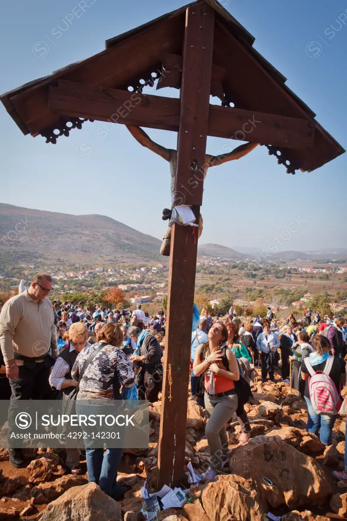 Bosnia and Herzegovina, Medjugorje, catholic pilgrims praying at a cross