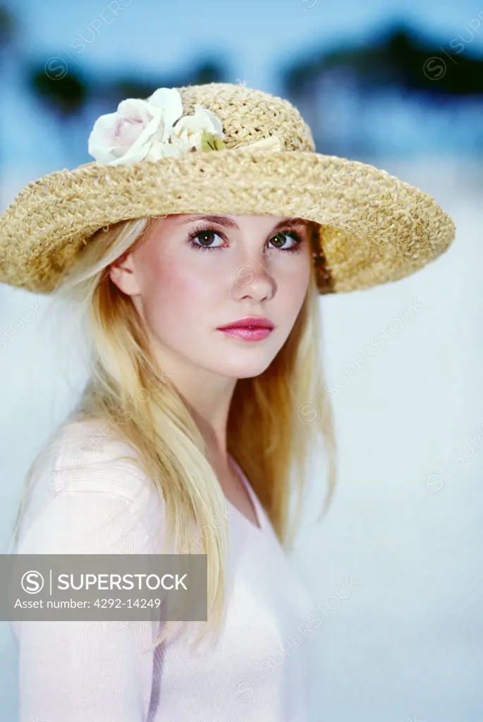 Portrait of blond woman with a strawy hat