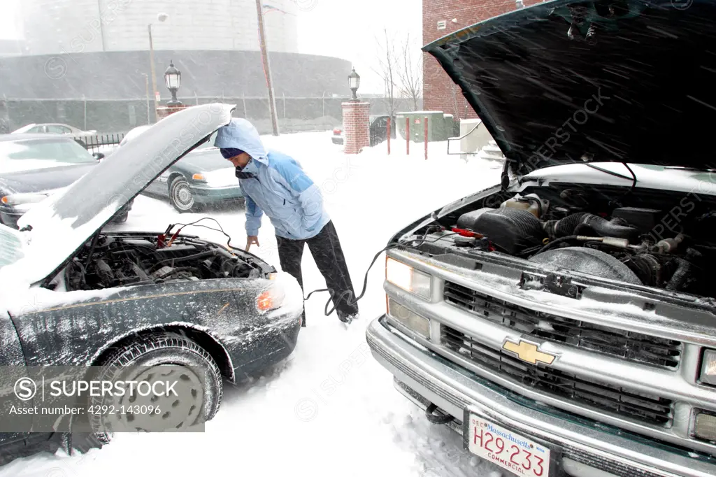 USA, Massachusetts, Boston, Woman Having Car Trouble in Snowstorm