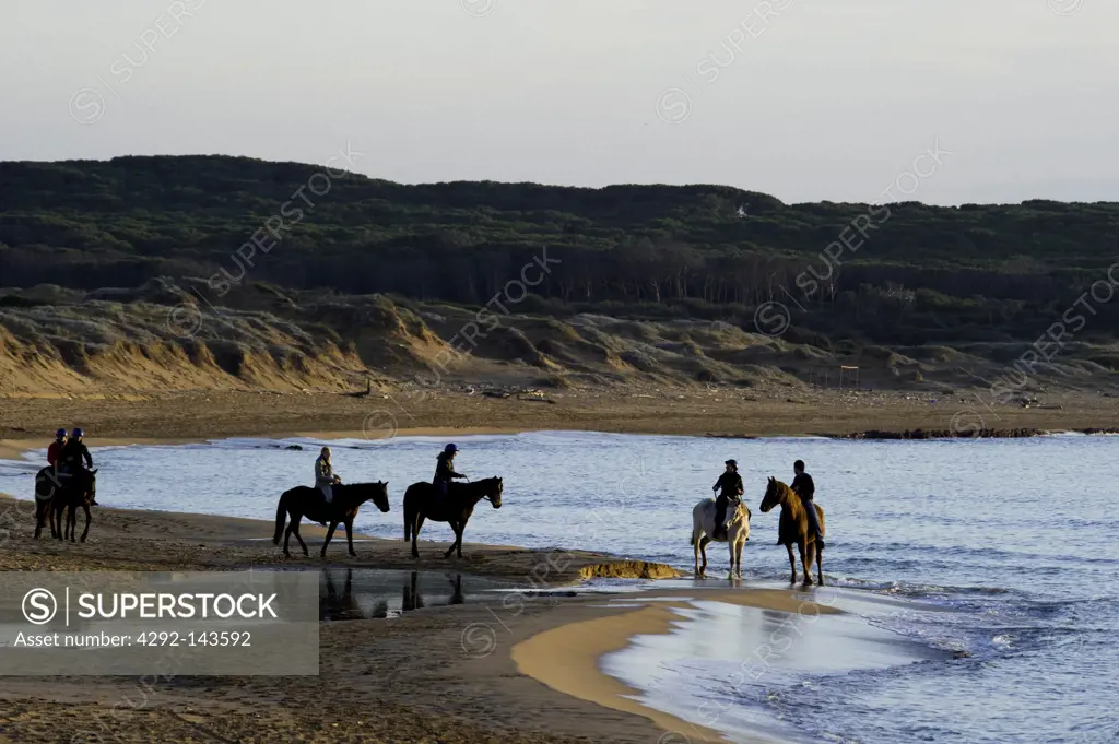 Italy, Sardinia, Sassari, Porto ferro, people on the beache, horse riding