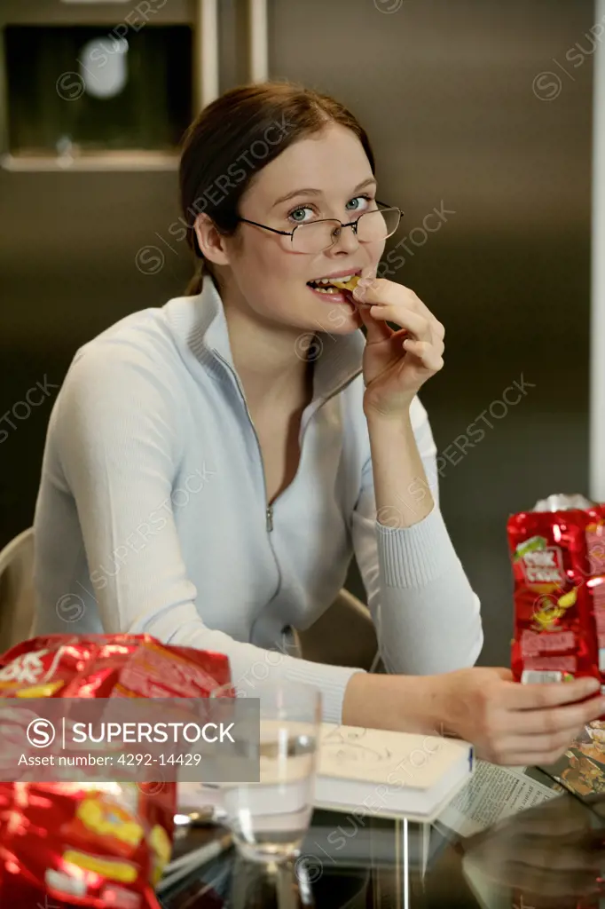 Woman eating potato chip