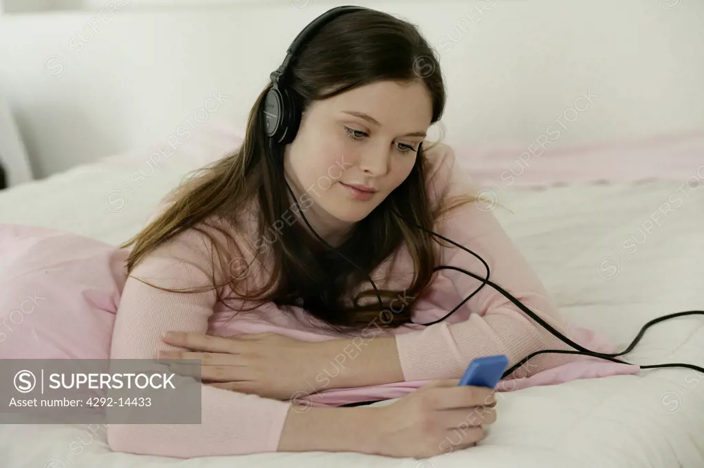 Woman listening to music with MP3 player