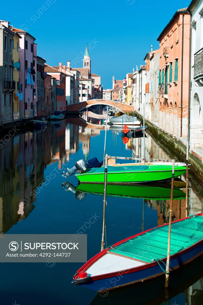 Italy, Chioggia, houses and boats on Canal Vena.