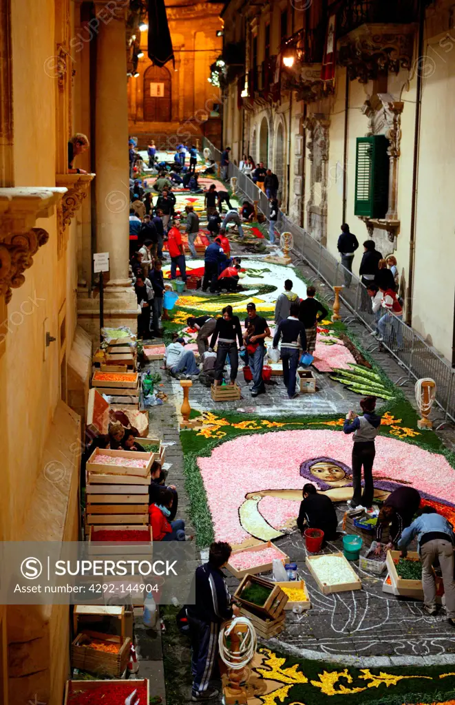 Italy, Sicily, Noto, young students works during the night to prepare the flower carpet decoration, the 'Infiorata'.