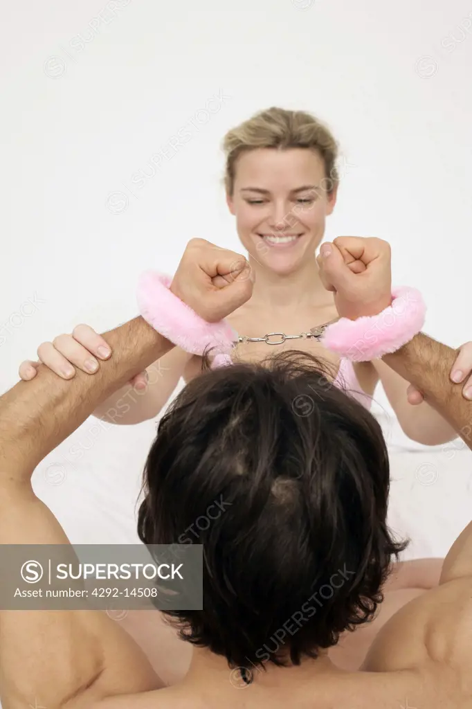 Playful couple, man with handcuffs
