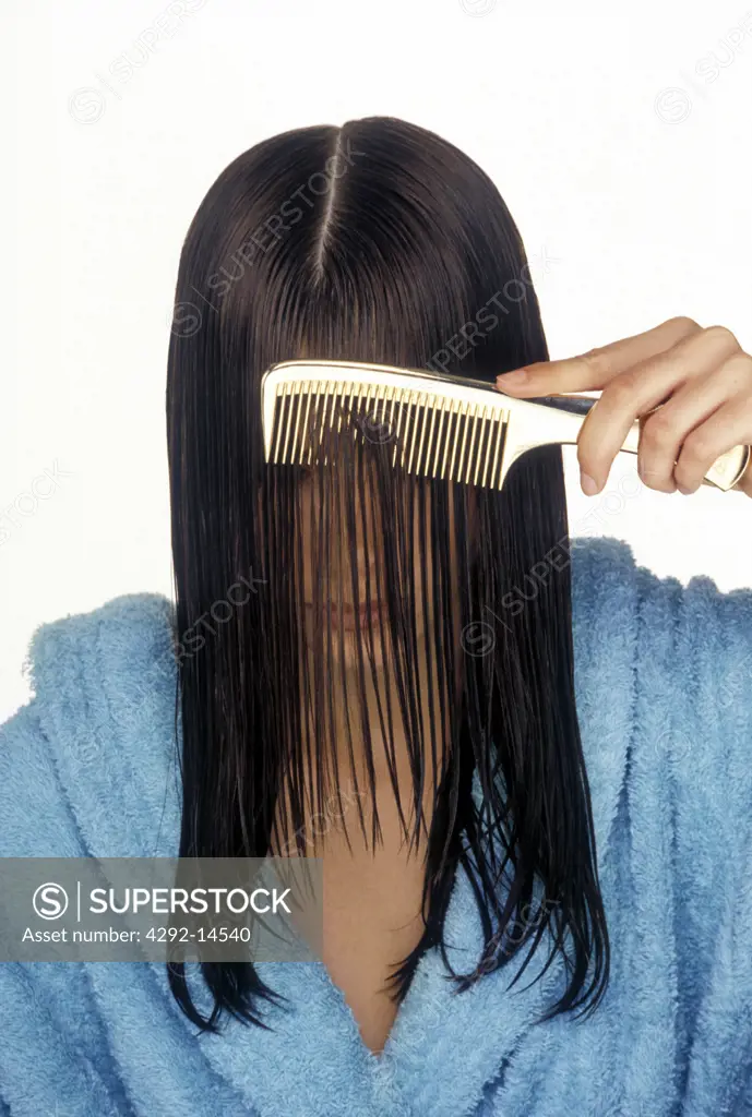 Woman combing her wet hair