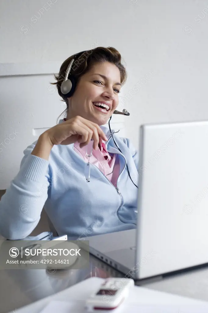 Woman with headphones and laptop