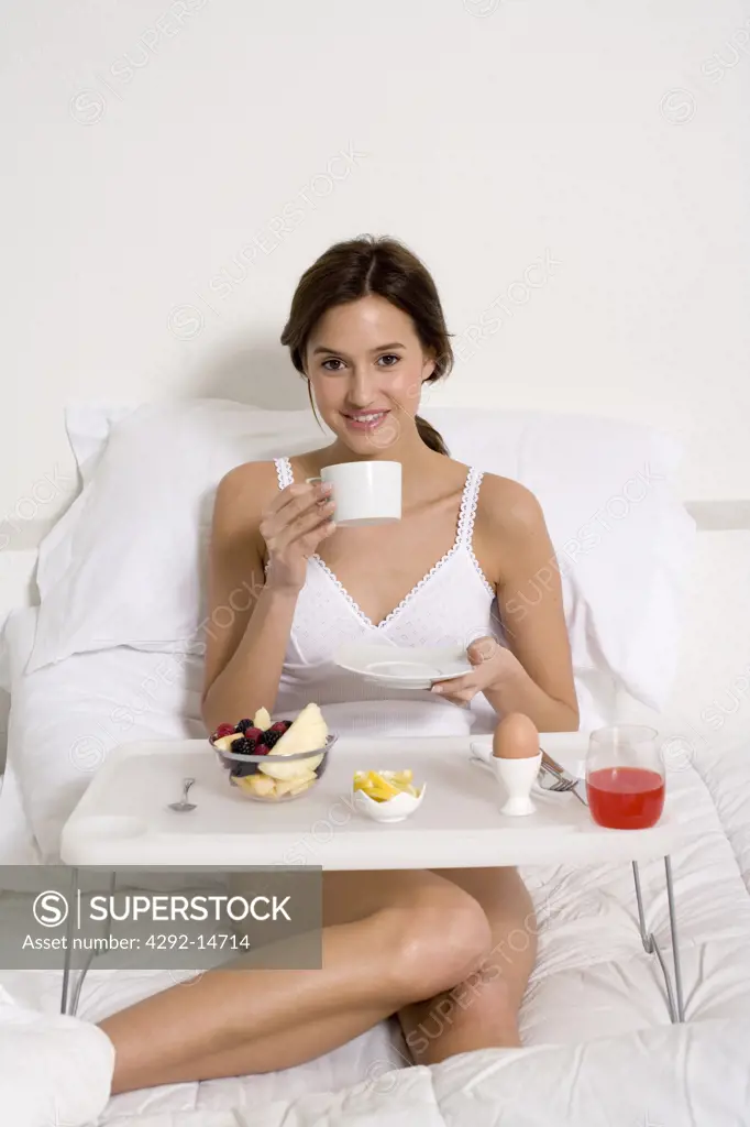 Woman having breakfast in her bed