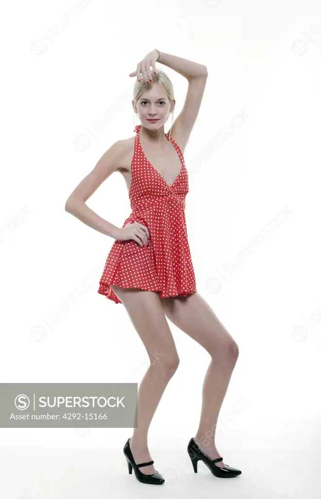 Studio shot of a young woman wearing red dress