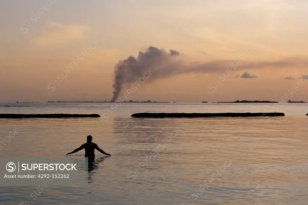 Garbage incineration plant smoking in background, North Male Atoll, Indian Ocean, Maldives
