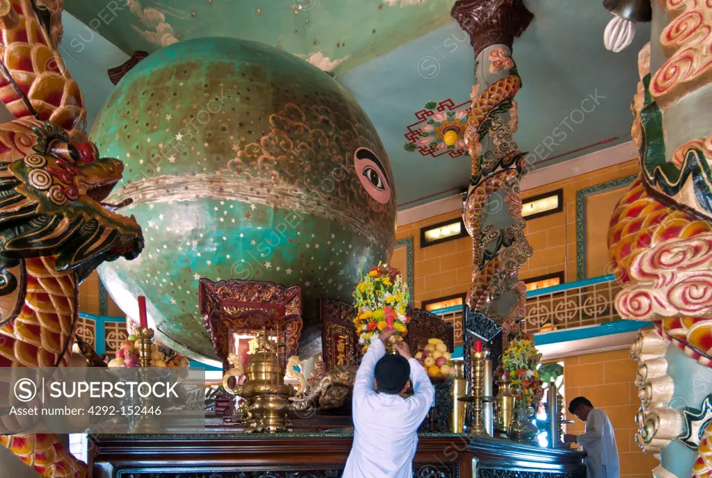 Vietnam, Cantho Prov, Mekong Delta, Priest decorating