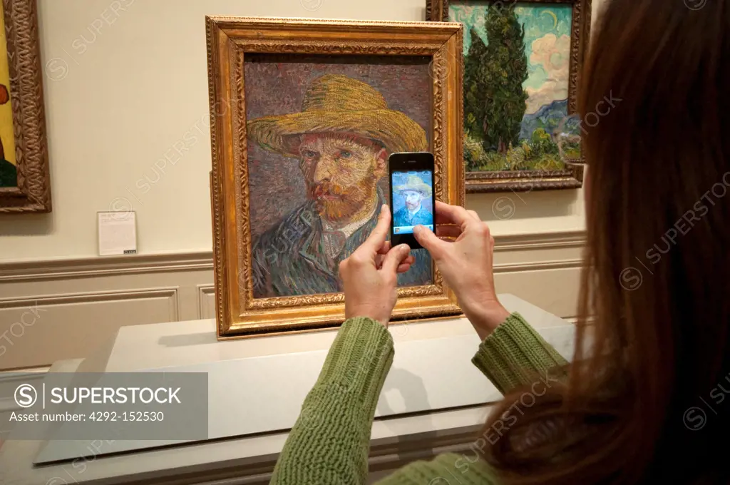 United States, New York City, Manhattan, East Side, Metropolitan Museum of Art, Woman Taking Picture Using an iPhone, Self Portrait with a Straw Hat by Vincent Van Gogh