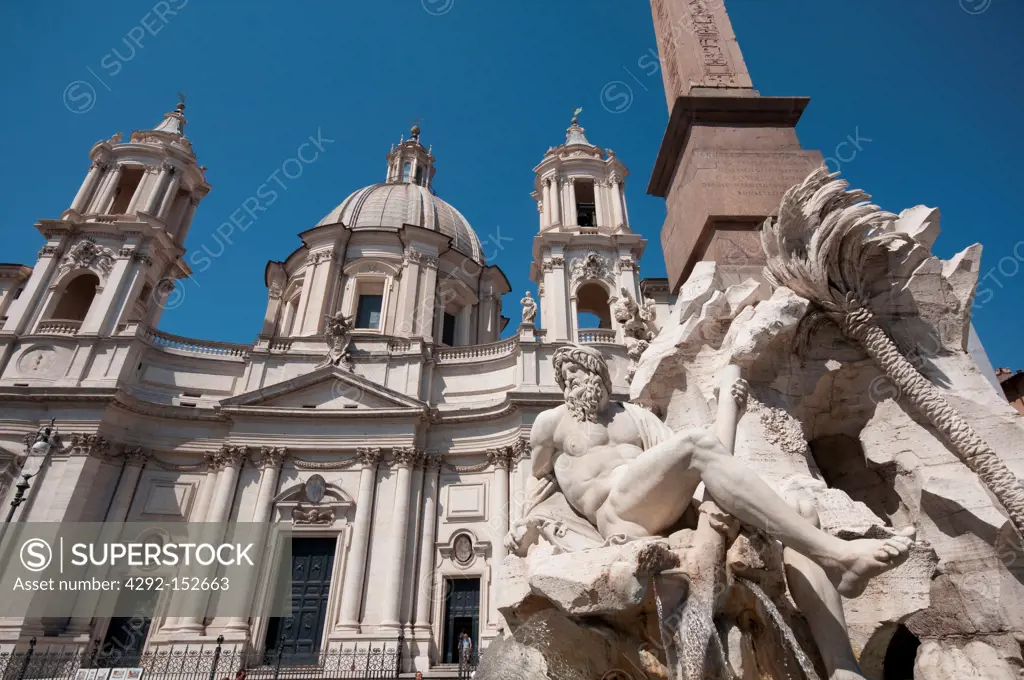 Italy, Lazio, Rome, Piazza Navona, Fountain of the Four Rivers background Saint Agnese in Agone Church