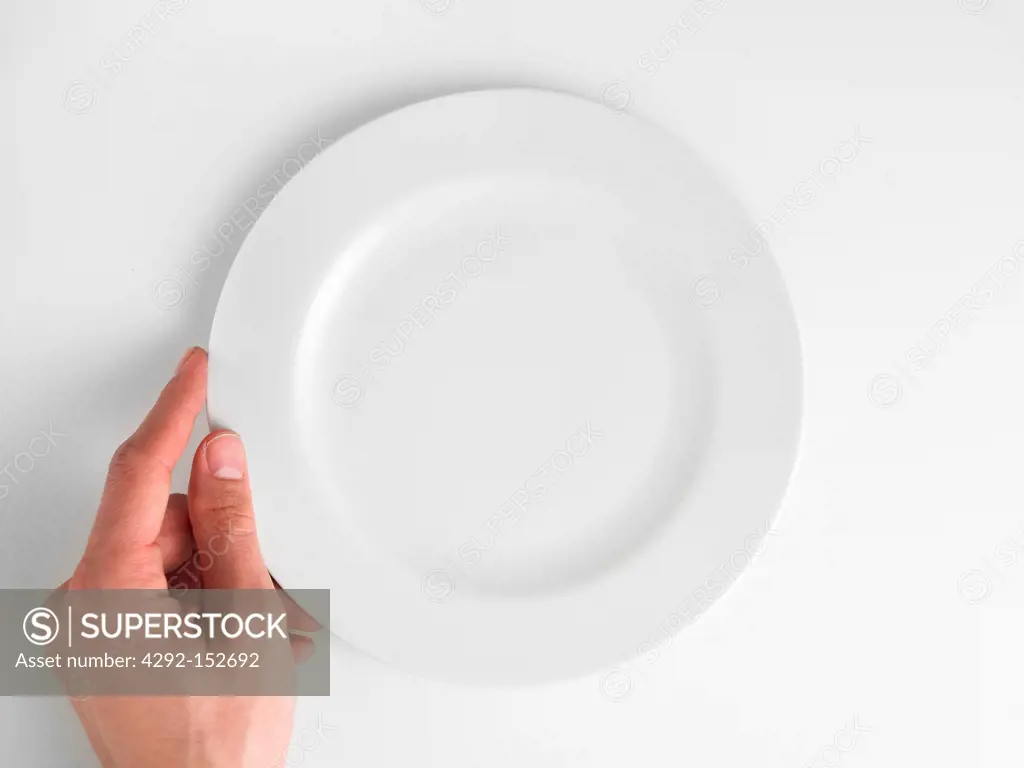 Empty plate with hand