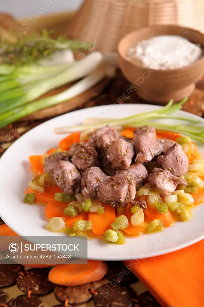 Rabbit medallions with green onions and carrots