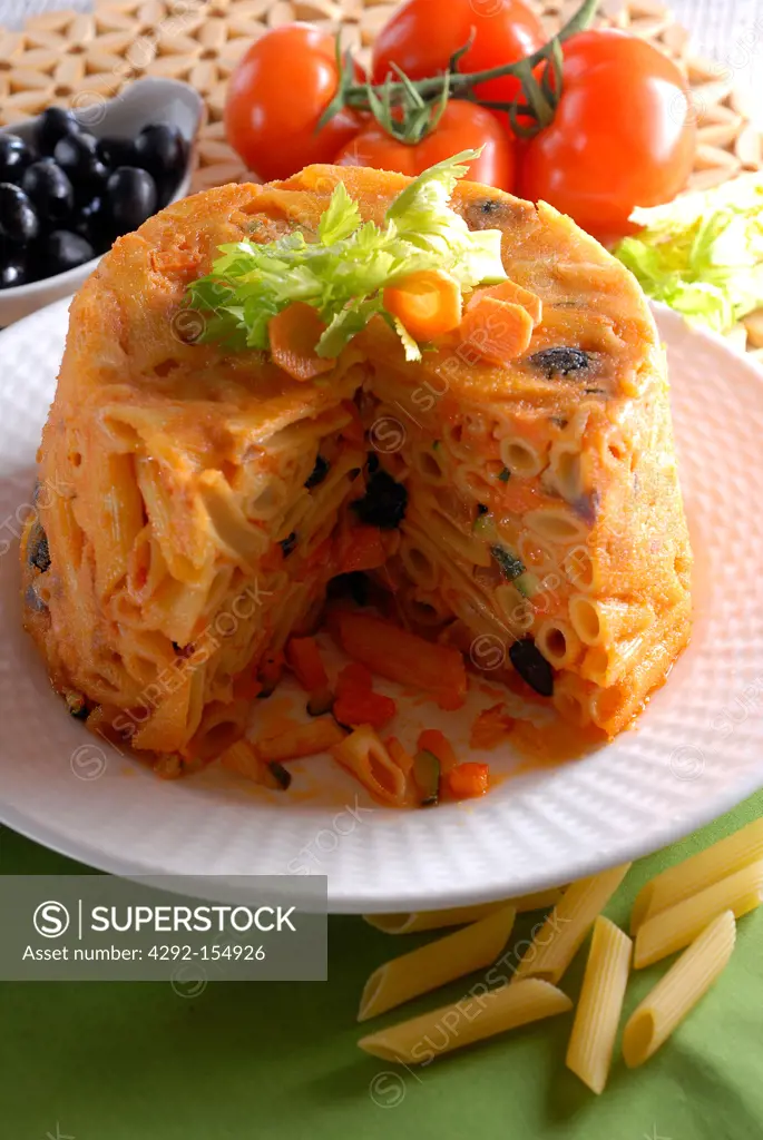 Timbale made with pasta, black olives, carrots, tomatoes and courgettes