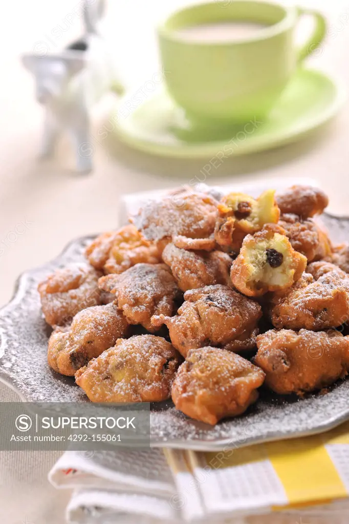 Apples and raisins fritters covered with powdered sugar