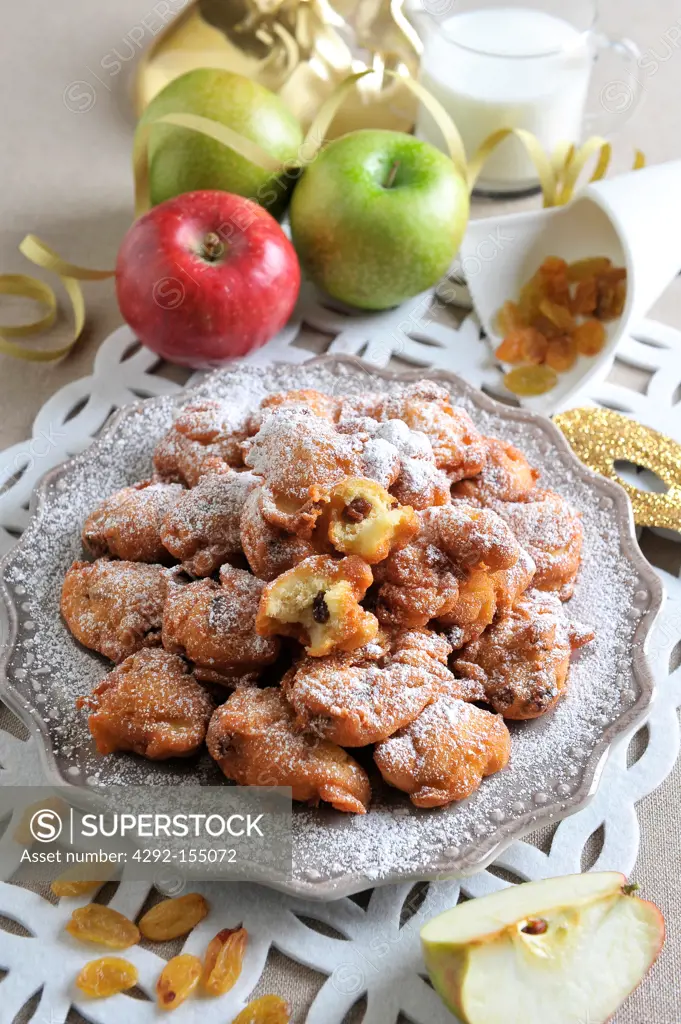 Apple and raisins fritters covered with powdered sugar