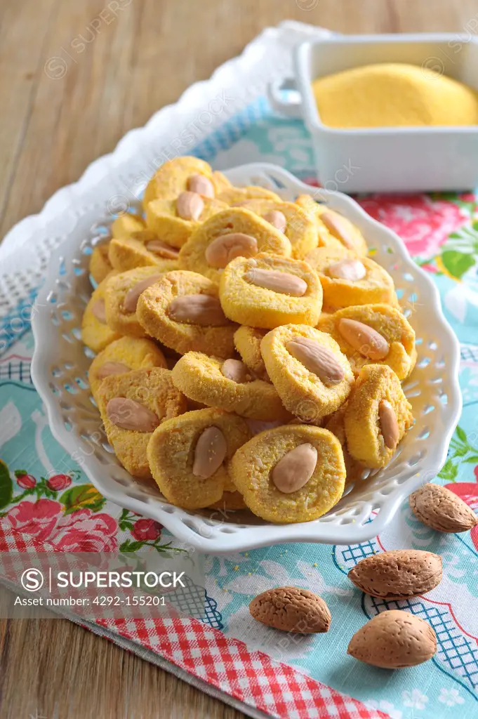 Little biscuits made with yellow flour, decorated with an almond