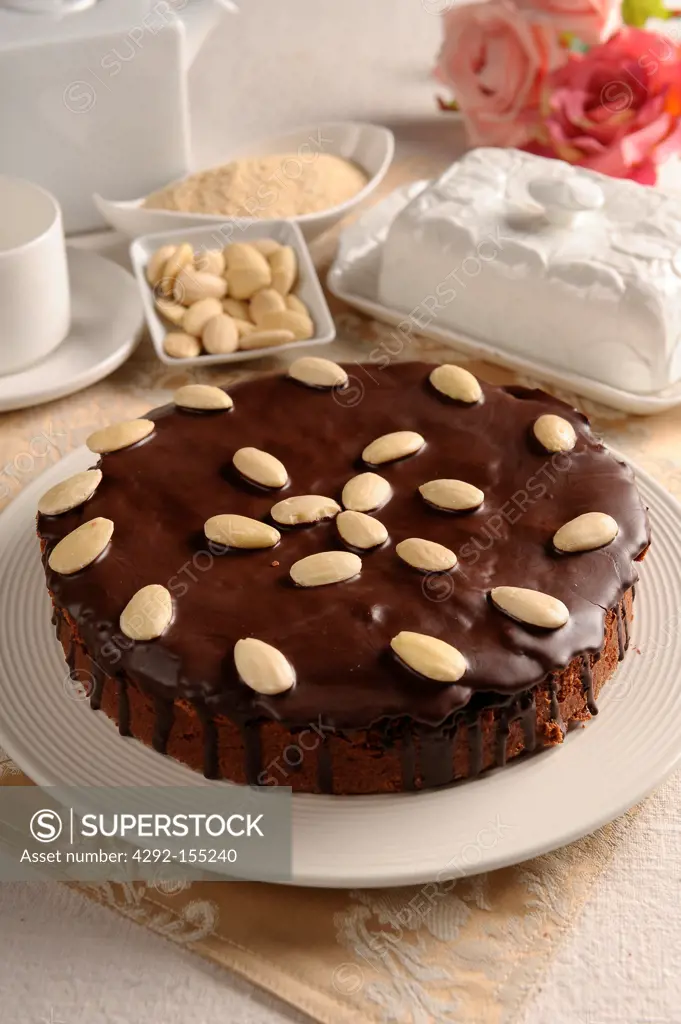 Breadcrumb and chocolate cake covered with chocolate and almonds