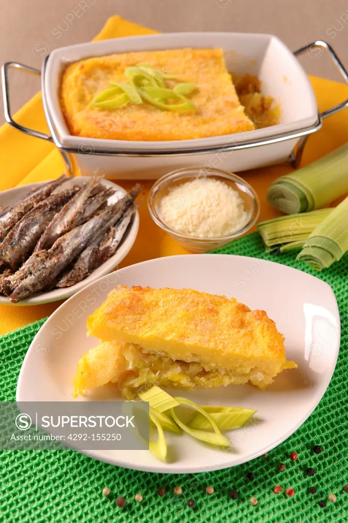 Slices of a cake made with polenta and filled with leeks, cheese and anchovy