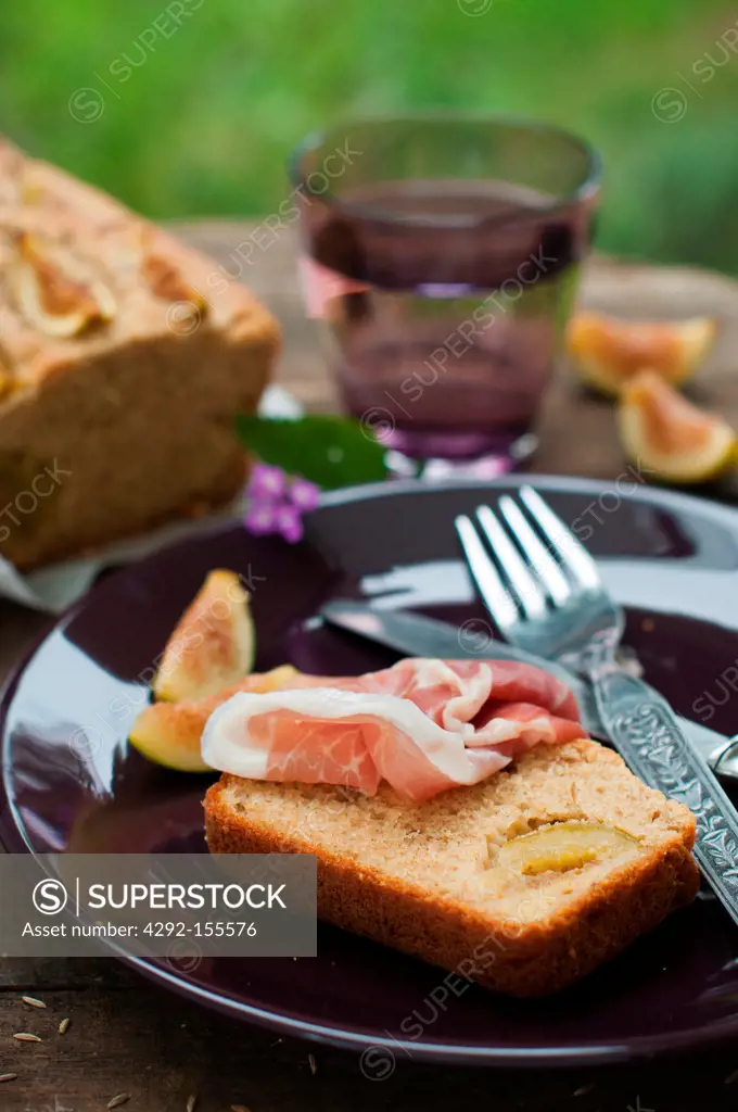 A slice of ham on figs cake