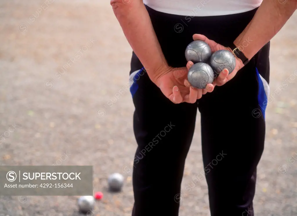 Men and women playing boules in town or city parks across Europe
