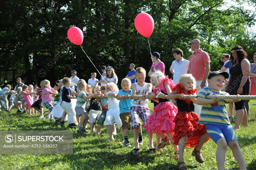 KIds playing tug-of-war games during Midsummer Celebrations in Sweden