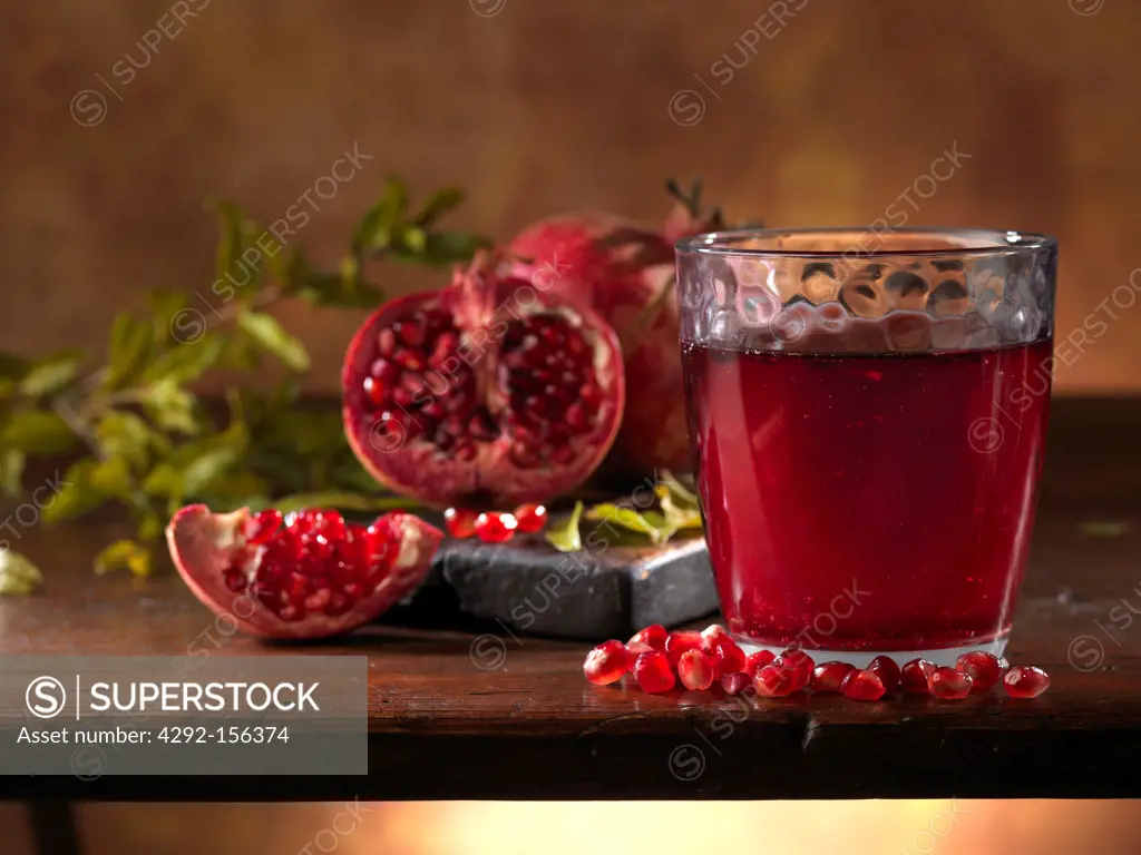 pomegranade with a glass of juice