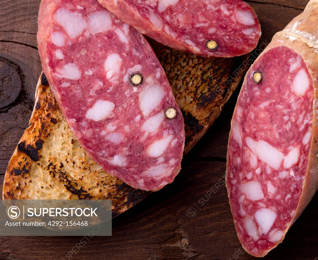 salami and bread on wood table