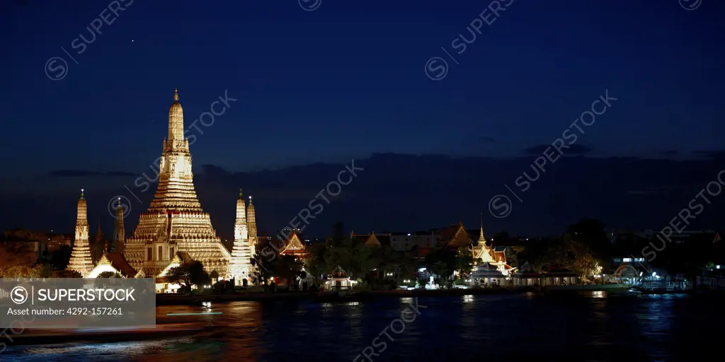 Wat Arun temple at night along the Chao Phraya River, Bangkok, Thailand