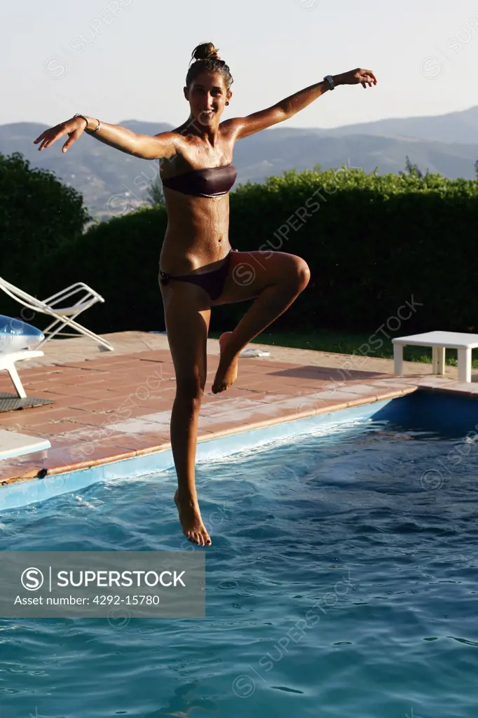 Woman jumping in pool