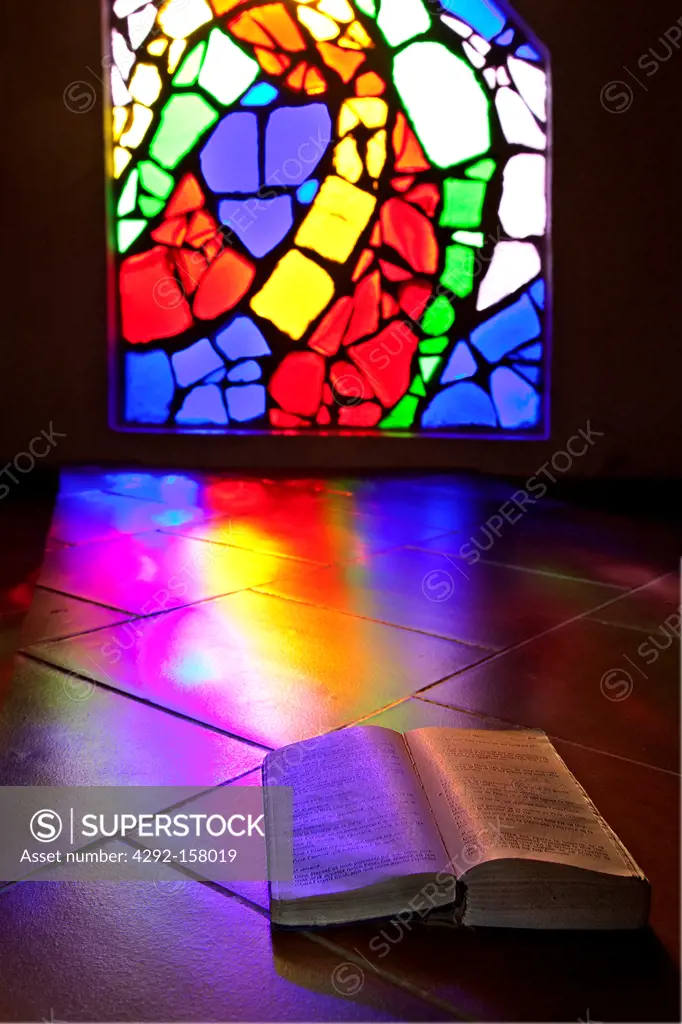 Book illuminated by a colorful stained glass