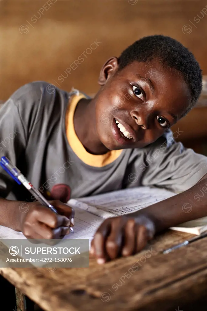 Africa, Republic Central Africa, schoolboy writes on a notebook