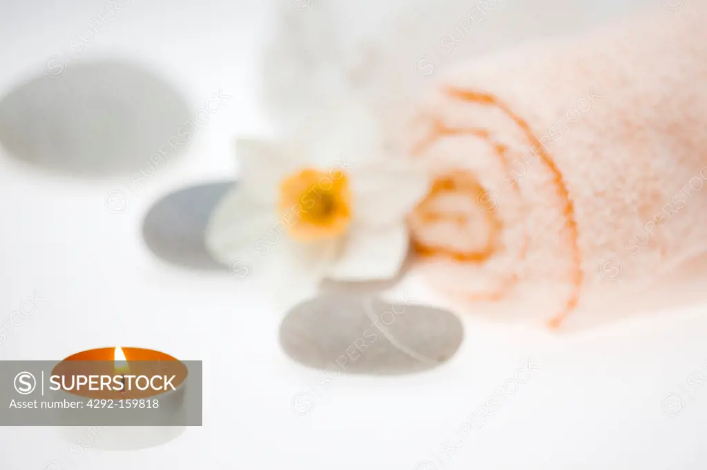 Spa elements for wellness:, grey stones, candle and flower