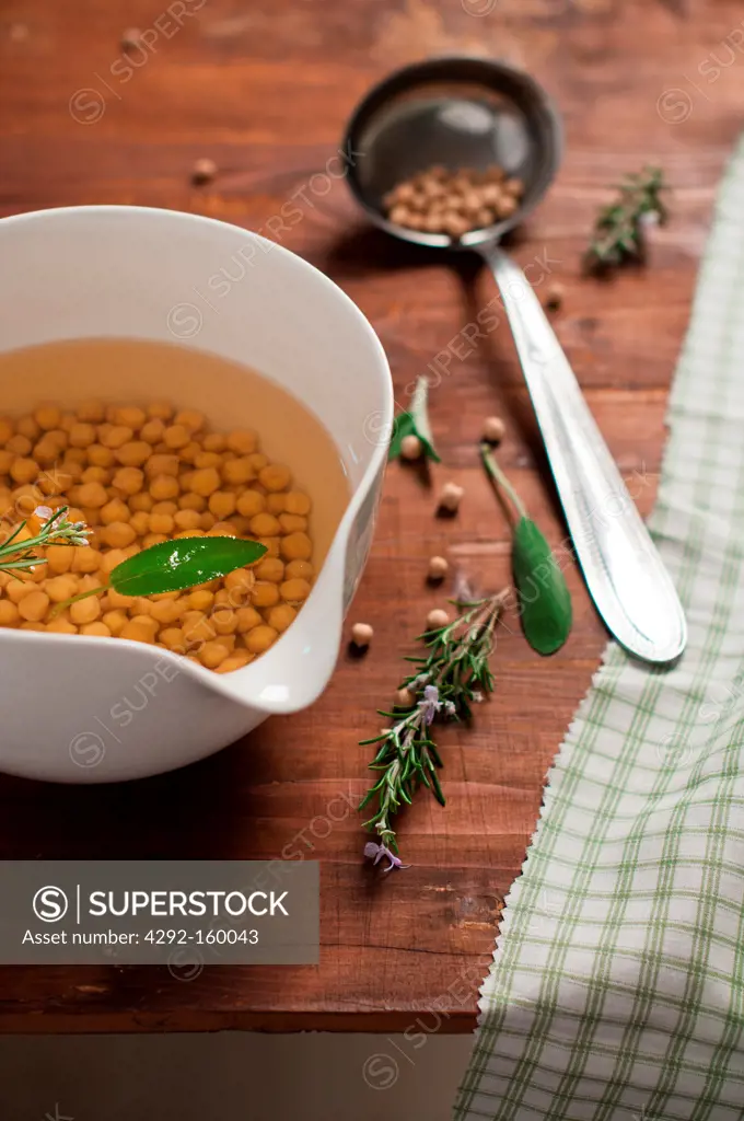 soak chickpeas with sage and rosemary in a bowl