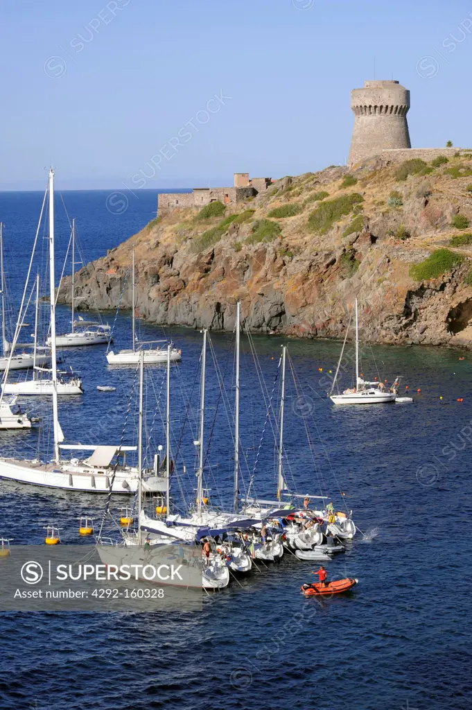 Italy, Capraia island (Tuscan Archipelago) yachts moored in the bay under the Genoese tower