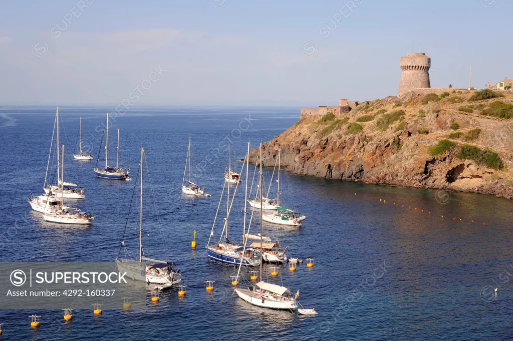 Italy, Capraia island (Tuscan Archipelago) yachts moored in the bay under the Genoese tower