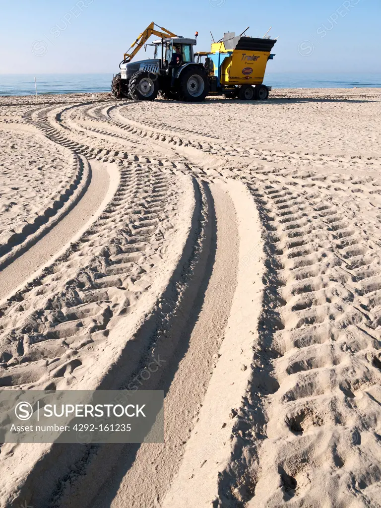 Tracked tractor and tracks on a sandy beach