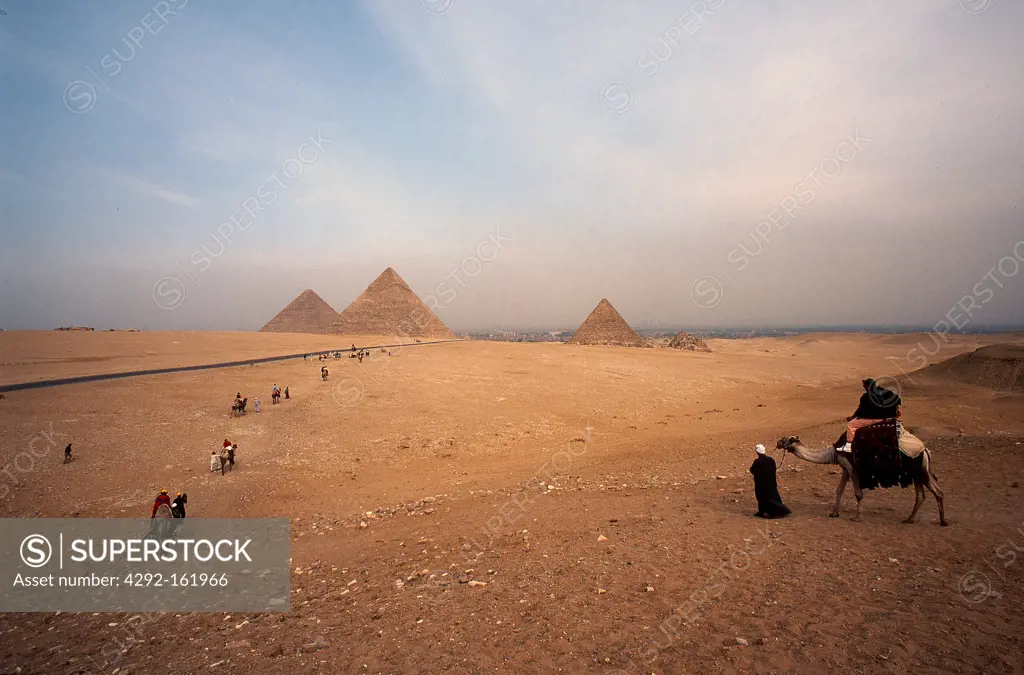 Egypt, Cairo. Giza Pyramids, Cheops,Chepren and Mycerinus and camel rider