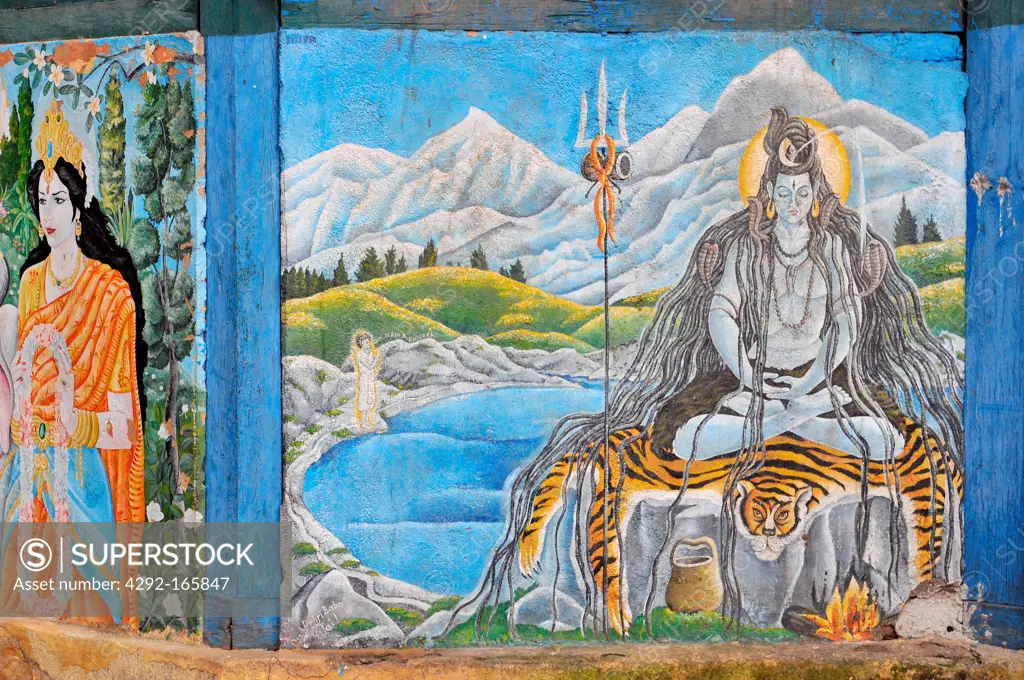 Nepal, Kathmandu, A painting of the Hindu god Shiva meditating in the Himalayas adorns the walls of a temple at Kathmandu's Pashupatinath.
