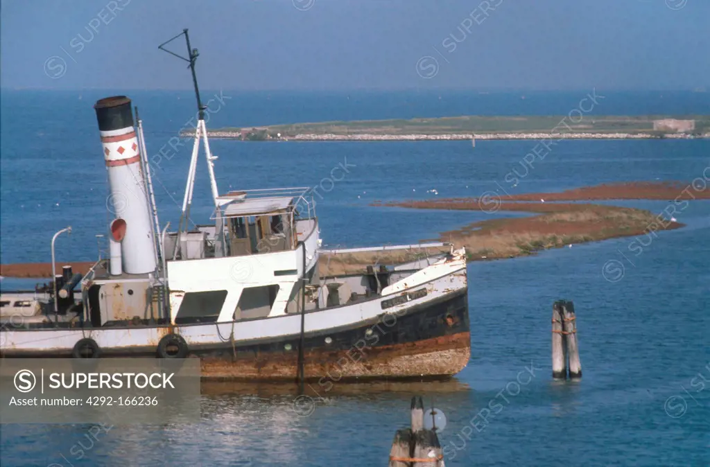 Italy, Veneto, Chioggia, old tug in disarmament abandoned in the lagoon