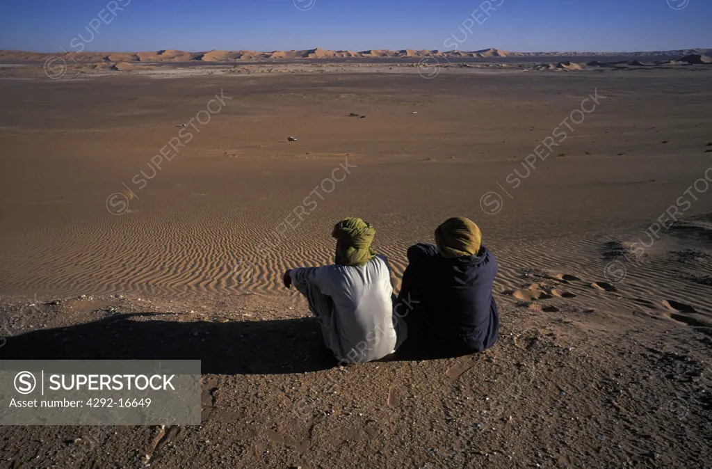 Algeria, Sahara, Erg Chech Desert, Two men sitting on the ground