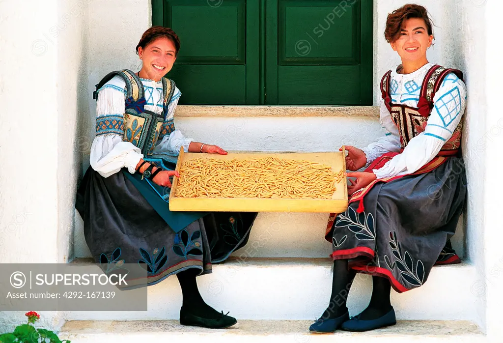 Italy, Apulia, folkloristic dress and typical cavatelli pasta