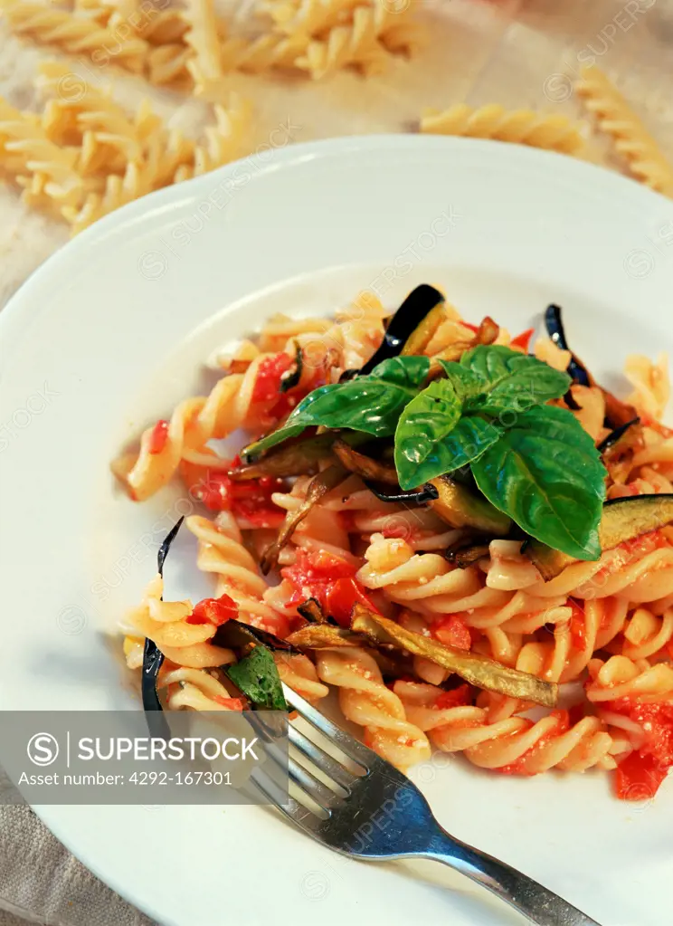 Italy, fusilli pasta with fresh tomatoes, fried aubergines and basil leaf