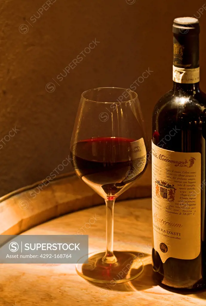 Italy, Piedmont, bottle of red wine with wineglass