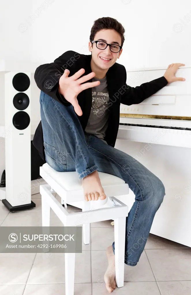 Teenaged boy with piano